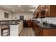 Finished basement bar showcasing custom cabinetry, countertops, tiled flooring, and stainless steel appliances at 3880 Heathfield Ct, Zionsville, IN 46077