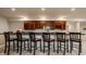 Finished basement bar features a long countertop with seating and custom wood cabinets with storage at 3880 Heathfield Ct, Zionsville, IN 46077