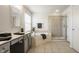 Bright bathroom featuring dual sinks, soaking tub, glass shower, and neutral tile flooring at 3880 Heathfield Ct, Zionsville, IN 46077