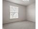 Neutral bedroom with large window and plush carpet flooring provides a serene space at 3880 Heathfield Ct, Zionsville, IN 46077
