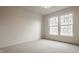 Bright bedroom with a large window and plush carpet flooring is a serene retreat at 3880 Heathfield Ct, Zionsville, IN 46077