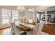 Elegant dining room featuring a rustic wood table, upholstered chairs, and hardwood floors at 3880 Heathfield Ct, Zionsville, IN 46077