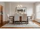 Formal dining room featuring a rustic wood table, upholstered chairs with nailhead trim, and hardwood floors at 3880 Heathfield Ct, Zionsville, IN 46077