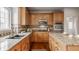 Bright kitchen featuring granite countertops, stainless steel appliances, wood floors and cabinets, and tile backsplash at 3880 Heathfield Ct, Zionsville, IN 46077