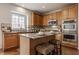 Well-equipped kitchen featuring granite countertops, stainless steel appliances, and a functional island with seating at 3880 Heathfield Ct, Zionsville, IN 46077