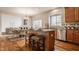 Stylish eat-in kitchen featuring an island with bar stool seating, stainless steel appliances, and an adjacent living space at 3880 Heathfield Ct, Zionsville, IN 46077