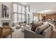 Spacious living room with a fireplace, large windows, and a view of the adjacent kitchen at 3880 Heathfield Ct, Zionsville, IN 46077