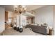 Open-concept living room with dining area, modern furnishings, and a staircase leading to the upper level at 3880 Heathfield Ct, Zionsville, IN 46077