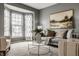 Comfortable living room showcasing a gray sofa, patterned armchairs, and a glass coffee table at 3880 Heathfield Ct, Zionsville, IN 46077