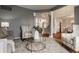 Inviting living room with gray walls, neutral furniture, and an open view of the foyer and staircase at 3880 Heathfield Ct, Zionsville, IN 46077