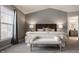 Bright main bedroom featuring a seating area, ceiling fan, neutral color scheme, and an ensuite bathroom at 3880 Heathfield Ct, Zionsville, IN 46077