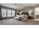 Calming main bedroom suite featuring three windows, a neutral color scheme, and an ensuite bathroom at 3880 Heathfield Ct, Zionsville, IN 46077