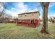 Home's backyard with a red deck and grassy lawn at 3968 Creekwood Dr, Greenwood, IN 46142