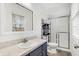 Well-lit bathroom featuring a modern vanity, updated flooring, and a glass-enclosed shower at 3968 Creekwood Dr, Greenwood, IN 46142