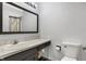Bathroom features a vanity with a sink, a large mirror, and a toilet at 3968 Creekwood Dr, Greenwood, IN 46142