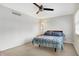 Cozy bedroom features a ceiling fan, neutral carpet, and natural light from a window at 3968 Creekwood Dr, Greenwood, IN 46142