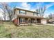 Charming two-story home with a brick facade, tan siding, well-manicured lawn, and green shutters at 3968 Creekwood Dr, Greenwood, IN 46142