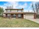 Charming two-story home with a brick facade, tan siding, well-manicured lawn, and an attached two-car garage at 3968 Creekwood Dr, Greenwood, IN 46142