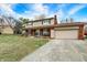 Charming two-story home with a brick facade, tan siding, well-manicured lawn, and a lengthy concrete driveway at 3968 Creekwood Dr, Greenwood, IN 46142
