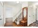 Bright foyer features hardwood floors, coat rack, staircase, and access to the living room at 3968 Creekwood Dr, Greenwood, IN 46142