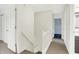 Well-lit hallway with a white banister that leads to bedrooms and bathrooms at 3968 Creekwood Dr, Greenwood, IN 46142