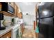 Eat-in kitchen featuring white appliances, wood cabinets, tile backsplash, and luxury vinyl flooring at 3968 Creekwood Dr, Greenwood, IN 46142