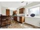 Kitchen featuring wood cabinets, luxury vinyl flooring, stainless steel appliances and breakfast bar at 3968 Creekwood Dr, Greenwood, IN 46142