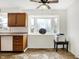 Kitchen showcasing wood cabinets, white appliances, and a large window overlooking the backyard at 3968 Creekwood Dr, Greenwood, IN 46142