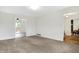Spacious living room with neutral carpet and access to the dining area and back deck at 3968 Creekwood Dr, Greenwood, IN 46142