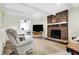 Cozy living room with a brick fireplace, white ceiling beams, and plush carpeting at 3968 Creekwood Dr, Greenwood, IN 46142
