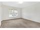 This living room features a large window, neutral tones and soft carpet at 3968 Creekwood Dr, Greenwood, IN 46142