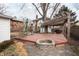 A wooden deck with a stone firepit and a rustic pergola offers a backyard retreat at 4212 Broadway St, Indianapolis, IN 46205