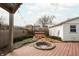 A backyard features a wooden deck with a firepit and a hot tub at 4212 Broadway St, Indianapolis, IN 46205