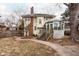Charming backyard features established landscaping and wooden steps that lead into conservatory at 4212 Broadway St, Indianapolis, IN 46205