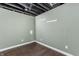 Finished basement space with durable laminate flooring and hooks for extra storage and organizing at 4212 Broadway St, Indianapolis, IN 46205