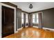 This bedroom features hardwood floors, ample natural light, and neutral paint scheme at 4212 Broadway St, Indianapolis, IN 46205