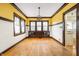 Bright dining room featuring hardwood floors, built-in cabinetry, and ample natural light, perfect for gatherings at 4212 Broadway St, Indianapolis, IN 46205
