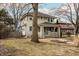 Classic two-story home boasting a mature landscape and welcoming front porch, blending charm with a serene outdoor setting at 4212 Broadway St, Indianapolis, IN 46205