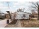Detached garage with a walkway leading to the back, and bare trees surrounding it at 4212 Broadway St, Indianapolis, IN 46205