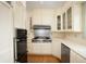 Kitchen with stainless steel appliances, wood floors, and ample cabinet space at 4212 Broadway St, Indianapolis, IN 46205