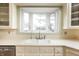 Bright kitchen featuring a bay window, apron sink, and white cabinetry at 4212 Broadway St, Indianapolis, IN 46205