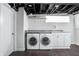 Bright laundry area in the basement features modern appliances, a sink, and storage cabinets at 4212 Broadway St, Indianapolis, IN 46205