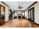 Spacious living room with hardwood floors, fireplace, staircase, and ample natural light, perfect for entertaining and relaxation at 4212 Broadway St, Indianapolis, IN 46205