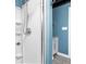 Modern shower with white fixtures and glass door features updated fixtures in renovated bathroom at 4212 Broadway St, Indianapolis, IN 46205