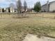 Large backyard featuring green space, established trees, and secure chain-link fencing at 457 Prince Dr, Greenwood, IN 46142