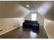 A bonus room with a large sectional and a vaulted ceiling at 457 Prince Dr, Greenwood, IN 46142