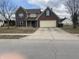 Charming two-story brick home with attached two car garage and a well manicured lawn at 457 Prince Dr, Greenwood, IN 46142