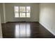 Bright living room with wood floors and large window at 457 Prince Dr, Greenwood, IN 46142