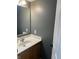 Clean powder room features a mirror, vanity, and light fixture at 457 Prince Dr, Greenwood, IN 46142