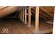 Spacious attic area with wooden framing and floorboards, offering ample storage or potential expansion at 4704 Whitview Ln, Indianapolis, IN 46237